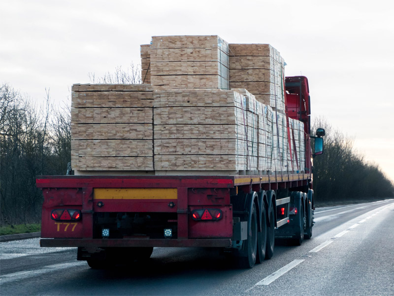 Truck transporting machinery